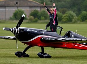 Melanie Astles waves to the crowd after her acrobatic display