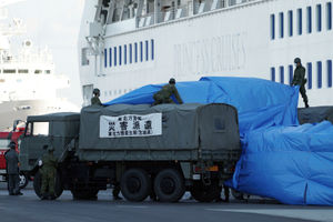Members of the Japan Self Defence Forces prepare a supply truck to link up with the cruise ship Diamond Princess