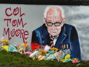 Supporting image for story: Flowers left in tribute to Sir Captain Tom at Black Country mural