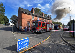 Smoke fills the sky as a fire takes hold in a derelict building on Newhall Street, Willenhall