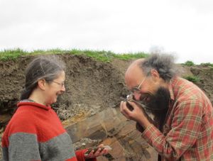 Undated handout photo of a Lucy Muir and Joe Botting examining a fossil specimen at Castle Bank