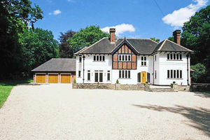The driveway leads up to the impressive home
