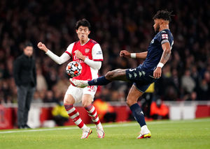 Arsenal's Takehiro Tomiyasu (left) and Aston Villa's Tyrone Mings battle for the ball