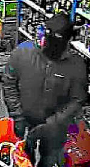 A robber in jacket, mask and gloves