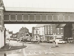 This undated photograph shows Shifnal railway bridge, with the premises of Pat Reeds, Staffordshire Building Society and Barclays in the background.