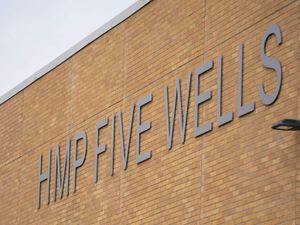General view of HMP Five Wells signage on a wall
