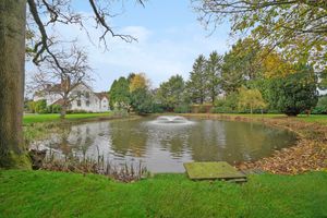 The manor buildings sit in nearly four acres of elegantly landscaped grounds featuring mature ponds and a circular fishpond that dates back to Victorian times.
