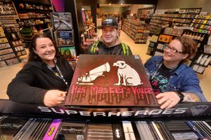 Ben Chipchase with art he made to give as a gift, pictured with staff members Elly Peake-Thornhill and manager Steph Kozakiewicz, right