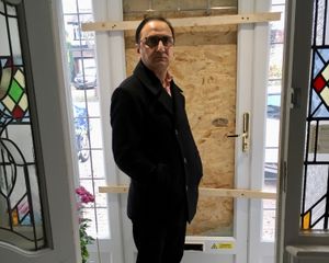 Councillor Waheed Rasab in front of his boarded up front door. Photo: Gurdip Thandi