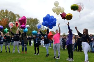 Balloons are released into the sky at Dell Stadium