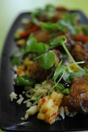 Pork with fruity salsa, rice and pea shoots
