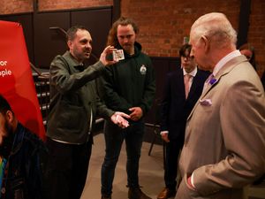 The King watches as magician Steven Frayne performs a trick