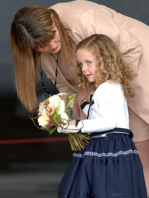 Chloe Willis, aged four, from Cosford, prepares to hand a posy to the Queen.