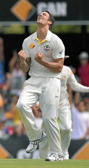 Australia's Mitchell Johnson celebrates taking the wicket of England's Graeme Swann for 0