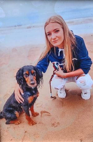 Lily-May Vaughan at the beach with her dog Sadie