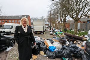 An image shows local resident Gail Burgess standing next to pile of bin bags and rubbish on Grove Cottage Road in Bordesley Green, Birmingham, with the ongoing bin strikes causing Christmas rubbish collection disruption.
