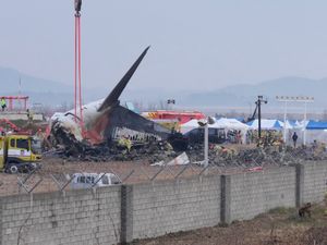 Rescue team members work at the site of a plane crash at an airport