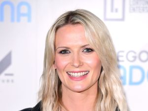 Headshot of Jo Wilson smiling at a red carpet event