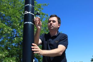 Lichfield District Council Cabinet Member Councillor Alex Farrell inspects a nitrogen dioxide diffusion tube used to measure the level of nitrogen dioxide in the air.