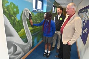 The school have had a mural painted for them by artist Neil Willis. Adults pictured areAnthony Nicholls from Anthonys of Wellington and Local resident: Jim McGinn (The are just two of a number of people who helped fund the project). Pupil: Dianne 10 with them.