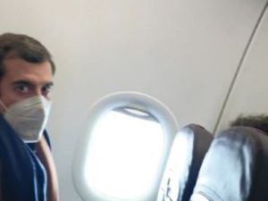 Someone in a mask sat on a plane