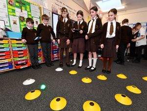 Pupils in a computing lesson learning how to control an object using computer programming