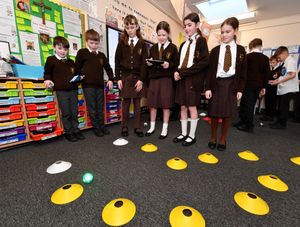 Pupils in a computing lesson learning how to control an object using computer programming 