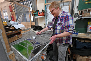 Nadia works on a stained glass window