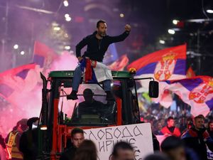 A man rides on the top of a tractor