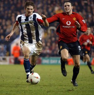 Scott Dobie races with John O'Shea for the ball.