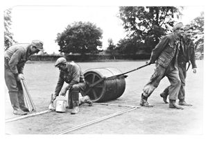 'Prisoners of War, Claverley Cricket Club' - rolling the grass and painting white lines at the club's new ground on July 12, 1947.