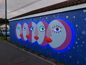 Supporting image for story: This artist created a colourful glowing mural to light up a dark Bristol road