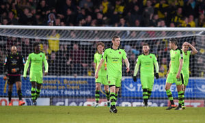 Players of Wolverhampton Wanderers stand dejected following the loss to Burton. (AMA Sports)