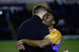 Shrewsbury Town boss Gavin Cowan celebrates with Kevin Berkoe following the win over Notts County