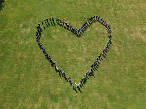 Pupils and staff at the school created a giant heart to celebrate the report's findings.