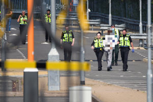 A man was handcuffed and put into an ambulance. Photo: SnapperSK