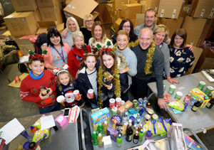 Steve and Kirsty Bull, with daughter Gracie, aged 11, and fellow volunteers packing boxes for the Steve Bull Foundation