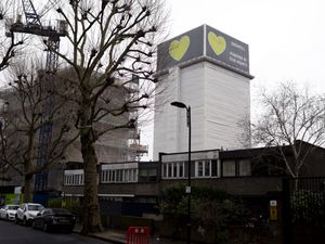 A view of Grenfell Tower covered in protective sheeting