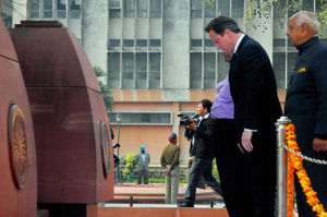 David Cameron pays his respects at the site of the massare in 2013