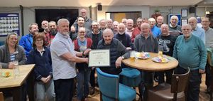 The choir chairman, Peter Cooke, is seen here presenting Stan with his certificate surrounded by choir members. Pictured left are Beth Howells (musical director), Bev Wightman (conductor) and Sally Oaks (piano accompanist)