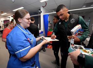  Walsall FC players met staff and patients at Walsall Manor Hospital and gave presents out for Christmas. out. Defender David Okagbue signs an autograph for a hard working nurse