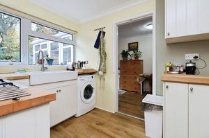 The kitchen is fully fitted and features a Belfast sink