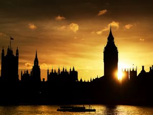 The sun sets behind the Houses of Parliament