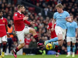 Manchester United’s Luke Shaw and Manchester City’s Kevin De Bruyne battle for the ball
