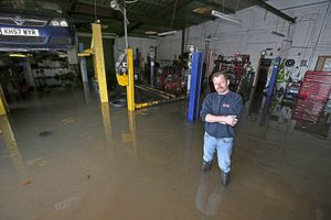Mechanic Andy Purcell in the flooded garage workshop