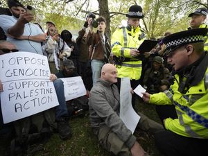 A demonstrator is read his rights by police at a Palestine Action protest, outside the Labour party conference in Liverpool
