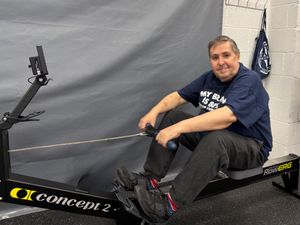 Stephen proudly trying out the new rower his fundraising brought.
