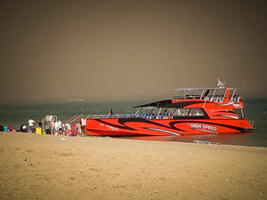Tourists stand on a beach after being evacuated during a forest fire on the island of Rhodes, Greece, Saturday, July 22, 2023. A large blaze burning on the Greek island of Rhodes for the fifth day has forced authorities to order an evacuation of four locations, including two seaside resorts. (Argyris Mantikos/Eurokinissi via AP)