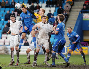 Christian Dibble of Stockport County punches this Telford corner clear as Andy Owens and Simon Grand of AFC Telford United challenge