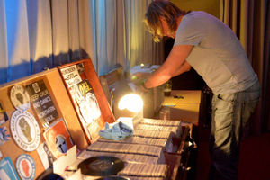 The DJ searches for the tune that will fill the floor.